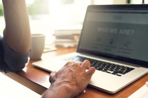 man on laptop, website homepage