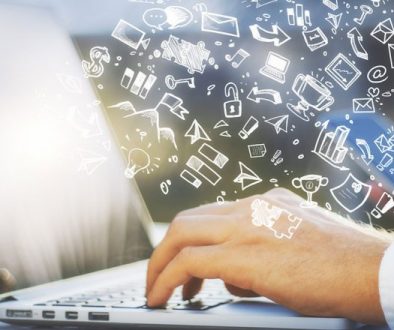 hand typing on laptop keyboard hand drawn icons floating over hand