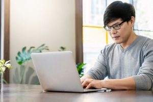Man at laptop typing