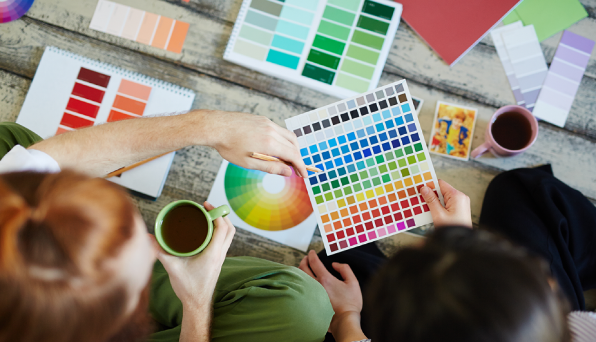 overhead of 2 people with color swatches and coffee