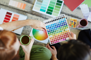 overhead of 2 people with color swatches and coffee