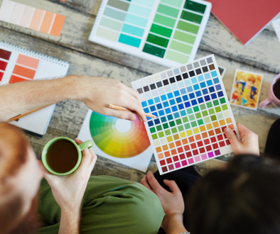 overhead of 2 people with color swatches and coffee