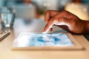 finger clicking on website on laptop