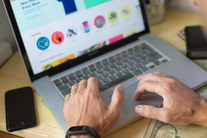 Man typing on laptop on website