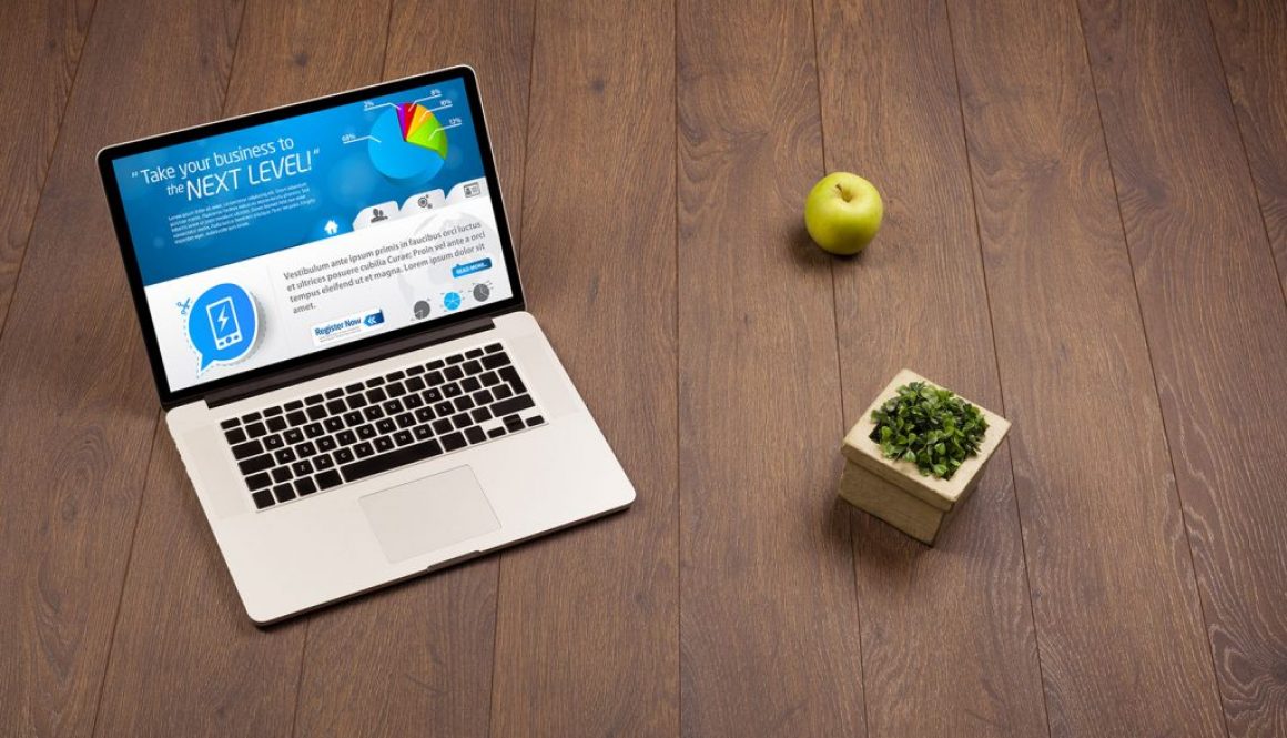 Laptop computer on wood background