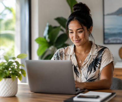 Young Hawaiian professional working on a laptop in a bright, modern office.