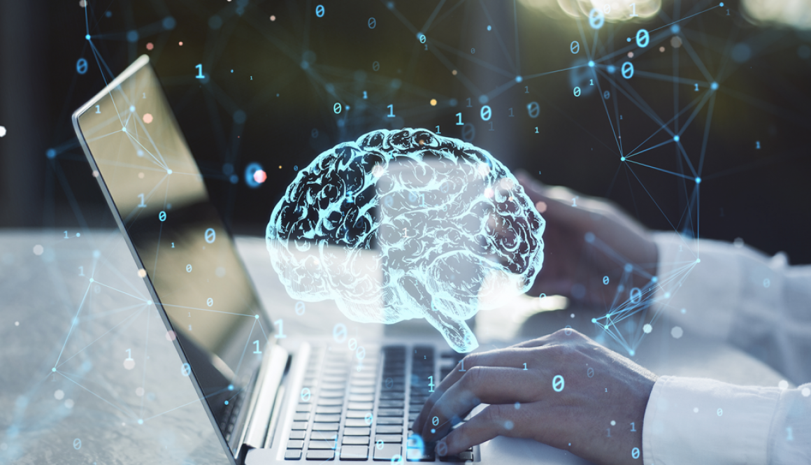 Brain graphic over laptop with person typing