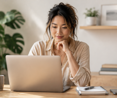 Young professional working on a laptop in a bright, modern home office.