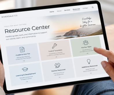 Person using a tablet to browse a website resource center with guides, tools, team resources, learning materials, and partner information.